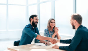 A life insurance broker shakes hands with one of his clients