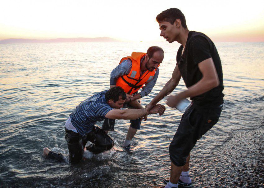 485528512-an-exhausted-syrian-man-is-dragged-out-of-the-water.jpg.CROP.promo-xlarge2