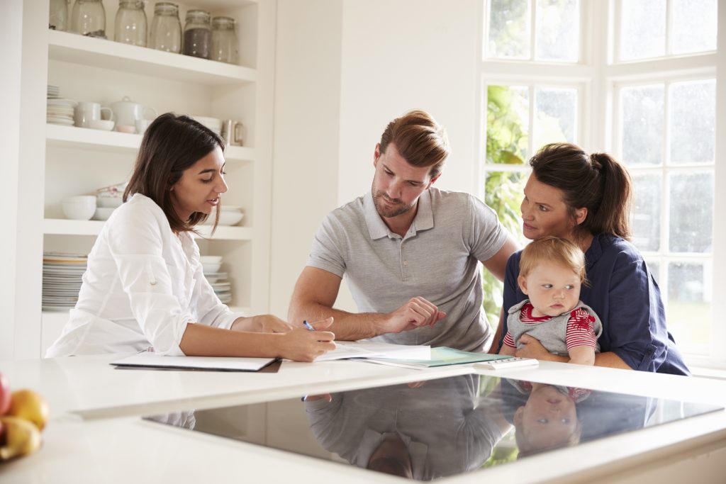A family reviews their life insurance with a broker