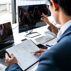 An investment banker reviews data on his computer