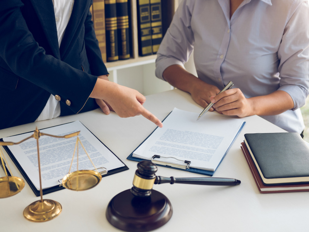 Two immigration lawyers discussing paperwork