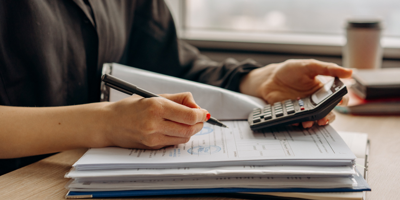 An accountant sits at a desk calculating numbers